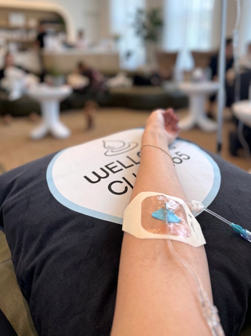 IV drip in a patient's arm resting on a Wellness Club 365 pillow